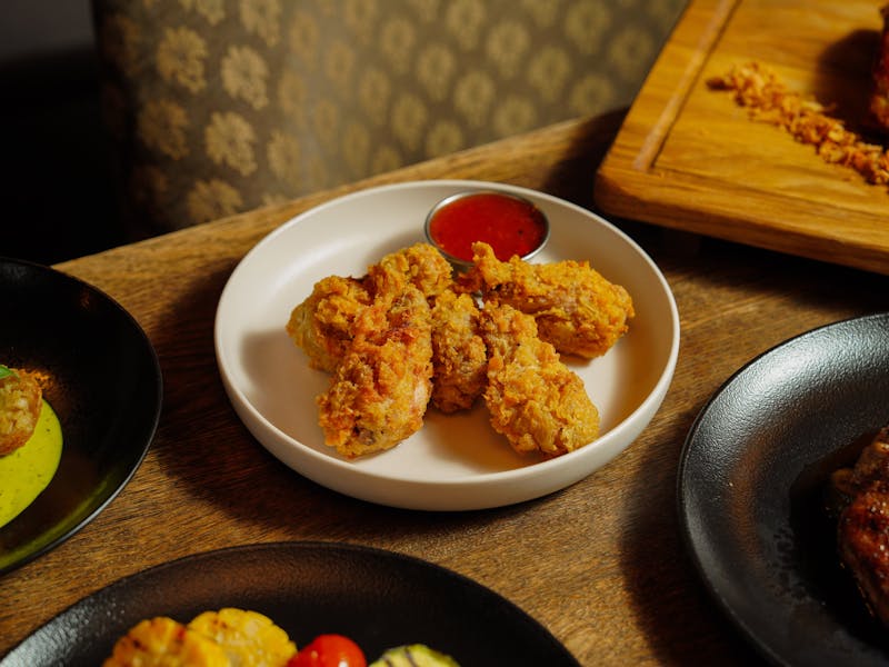 Crispy chicken wings with dipping sauce at Dions
